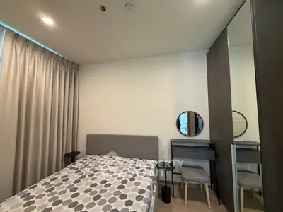 Modern bedroom with stylish decor and ample natural light