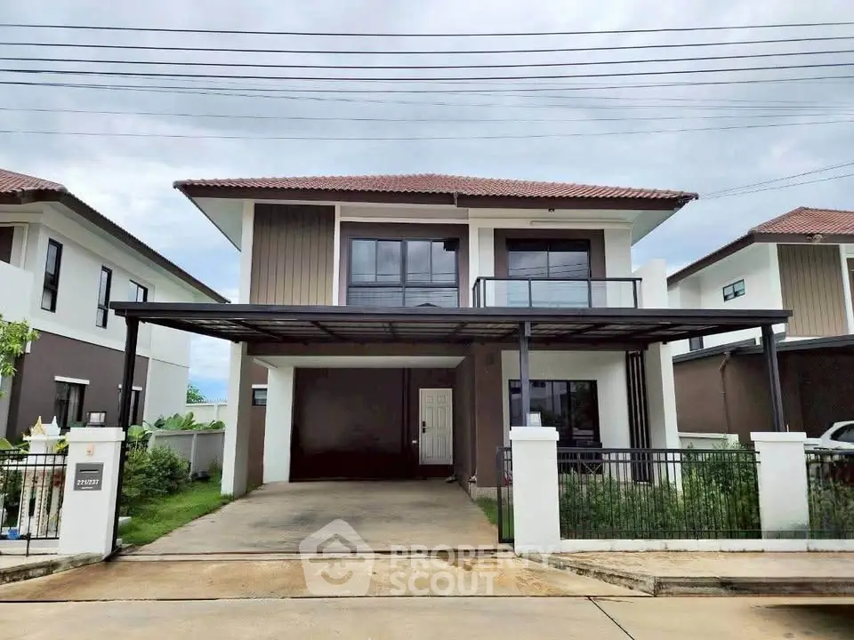 Modern two-story house with spacious driveway and balcony in suburban neighborhood.