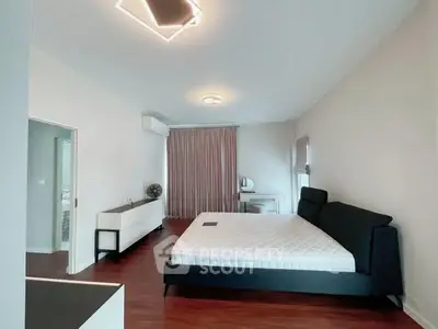 Spacious modern bedroom with sleek design and ample natural light