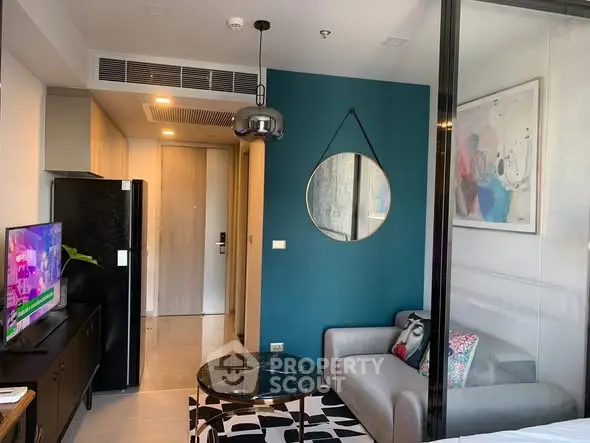 Modern living room with stylish decor, featuring a cozy sofa, wall art, and a flat-screen TV, perfect for urban living.