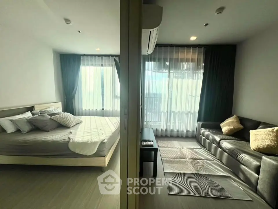 Modern bedroom and living room with large windows and stylish decor