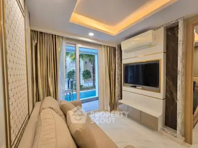 Luxurious living room with modern decor and pool view, featuring elegant lighting and stylish furnishings.
