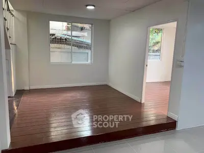 Spacious living area with wooden flooring and natural light, ideal for modern living.