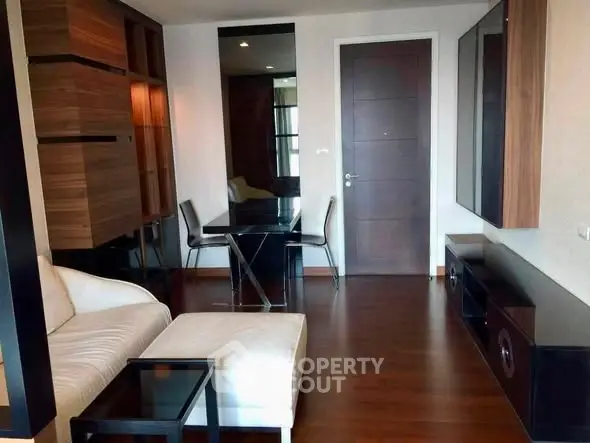 Modern living room with sleek furniture and wooden flooring