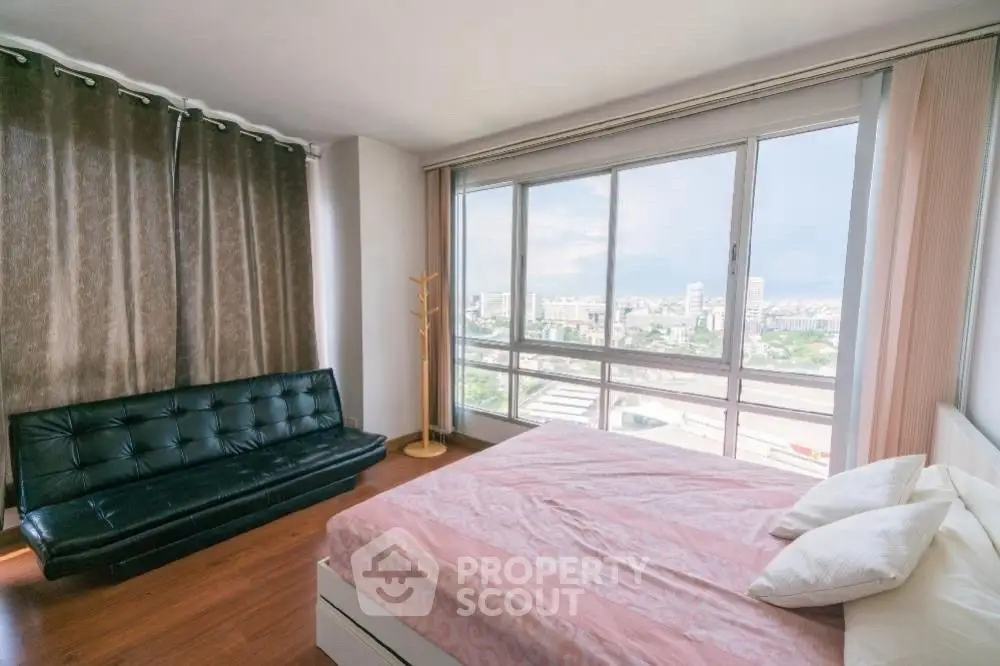 Spacious bedroom with stunning city view and modern furnishings
