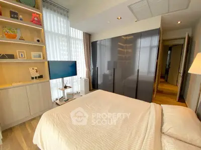 Modern bedroom with sleek wardrobe and cozy decor in a stylish apartment.