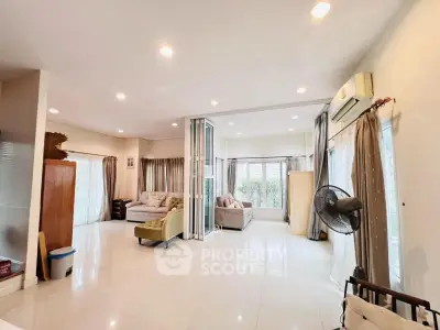 Spacious living room with modern decor and ample natural light