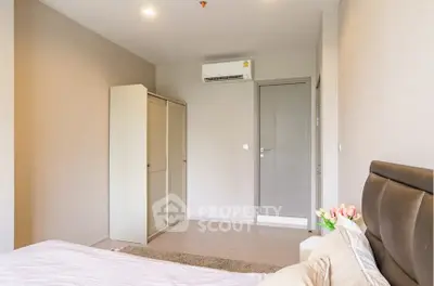 Spacious bedroom with modern decor and air conditioning unit, perfect for comfort and relaxation.