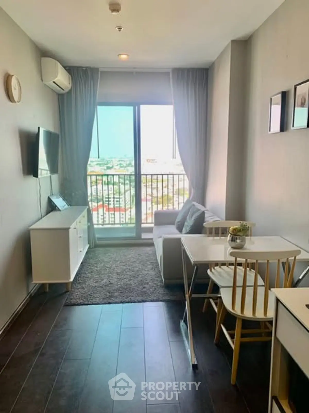 Modern living room with balcony view, sleek furniture, and natural light.