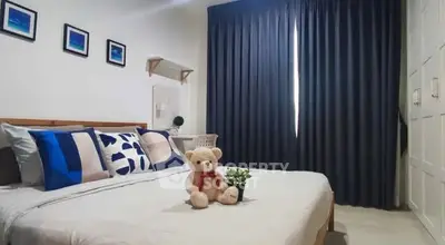 Cozy bedroom with stylish decor and plush bedding, perfect for relaxation.