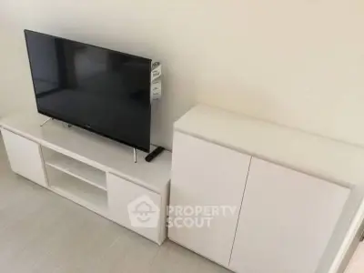 Modern living room with sleek TV stand and cabinet, perfect for minimalist decor.