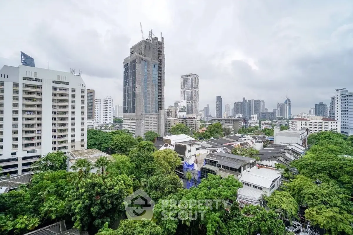 Stunning cityscape view with lush greenery and modern skyscrapers.