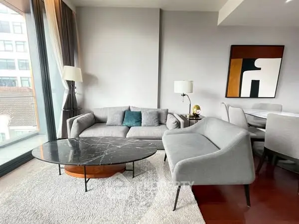 Modern living room with stylish furniture and large windows offering natural light.