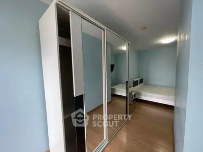 Spacious bedroom with mirrored wardrobe and modern design