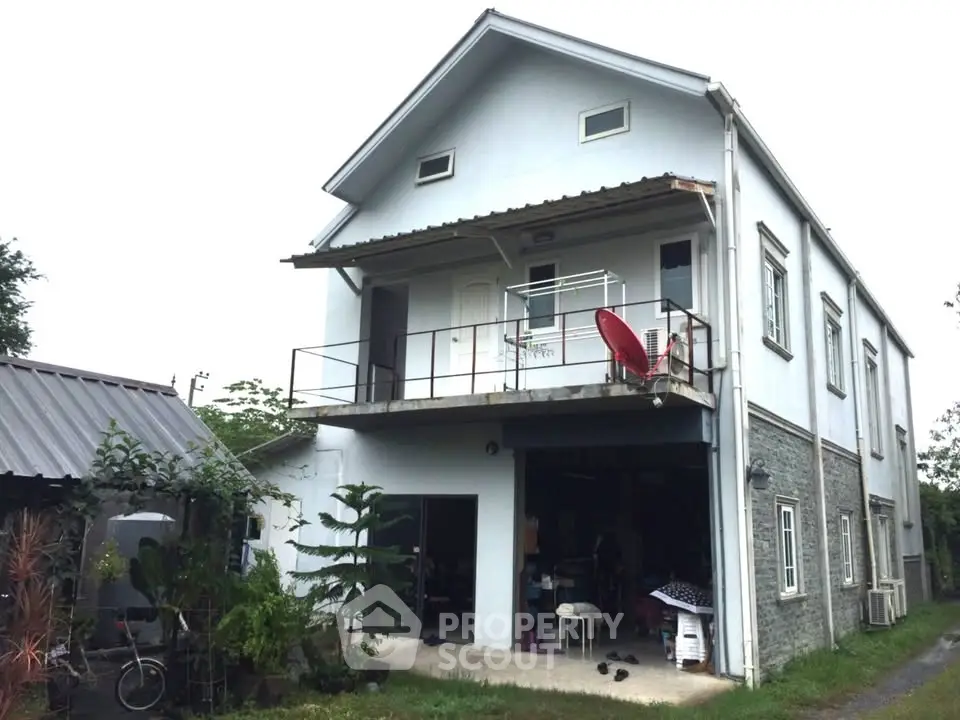 Charming two-story house with balcony and spacious garage in a serene neighborhood.