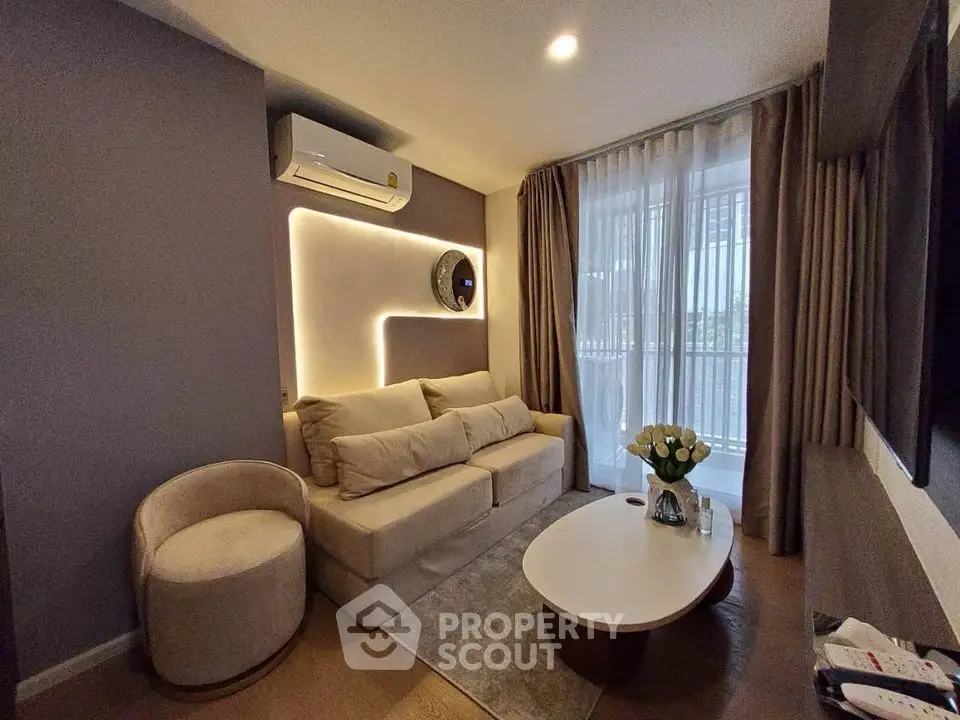Modern living room with cozy sofa, elegant lighting, and balcony view
