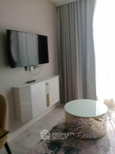 Modern living room with wall-mounted TV and elegant coffee table