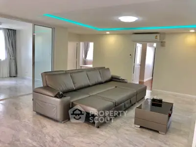 Spacious modern living room with sleek leather sofa and elegant marble flooring
