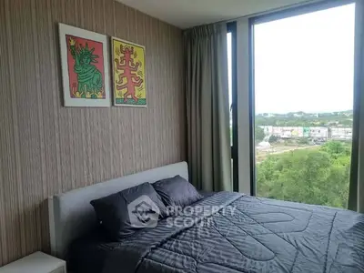 Modern bedroom with large window offering scenic views and stylish decor.