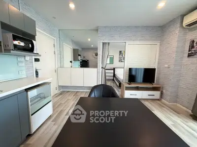 Modern open-plan living room with stylish kitchen and dining area in a contemporary apartment.
