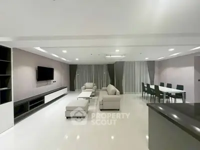 Spacious modern living room with elegant furniture and open dining area