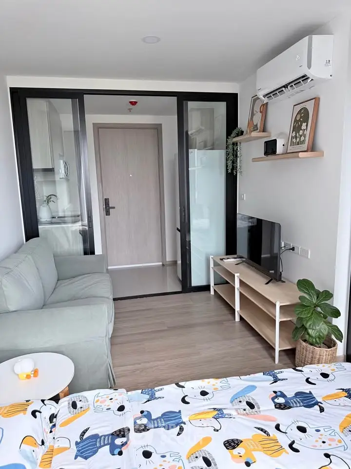 Modern studio apartment with cozy living area and stylish decor