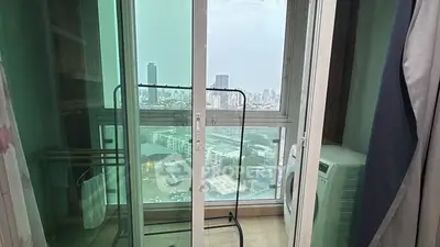 Charming balcony with city view and laundry area in modern apartment
