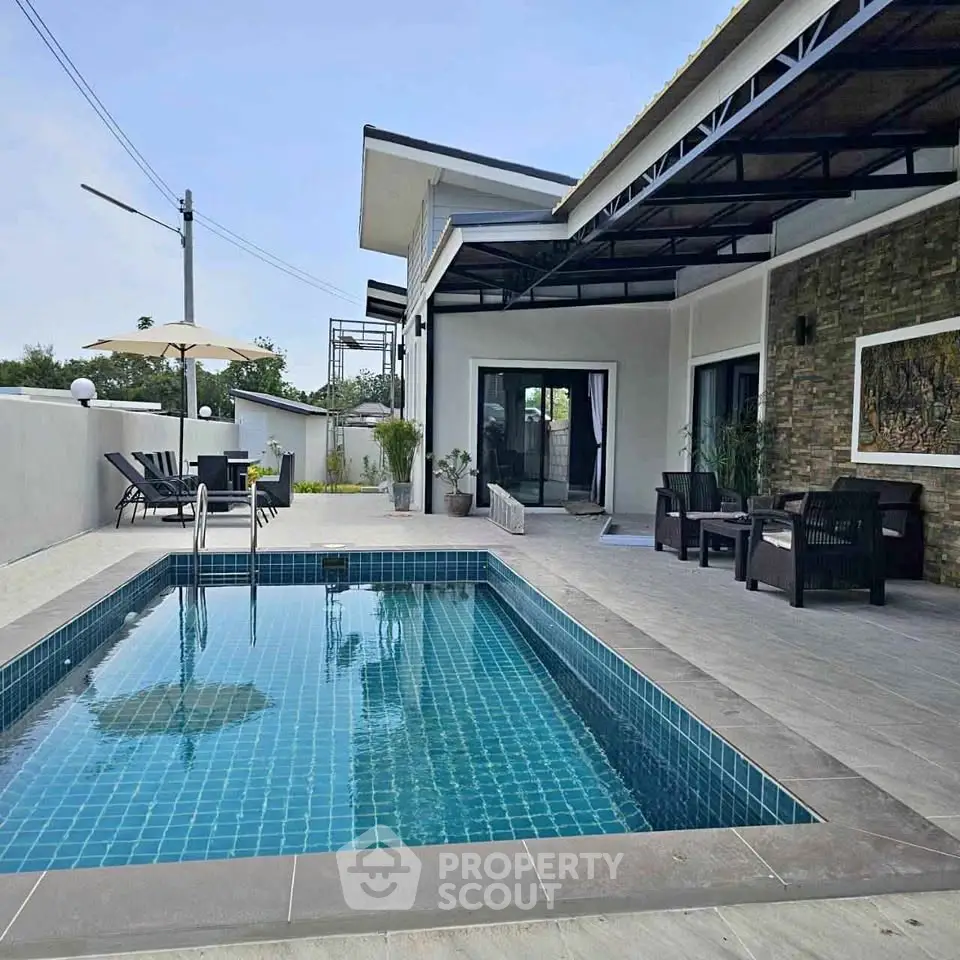 Modern villa with private pool and stylish outdoor seating area.