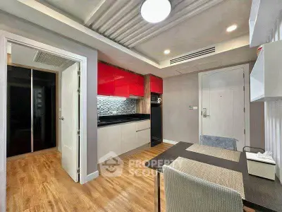 Modern kitchen with red cabinets and dining area in stylish apartment