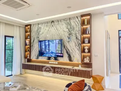 Luxurious living room with marble accent wall and built-in shelving