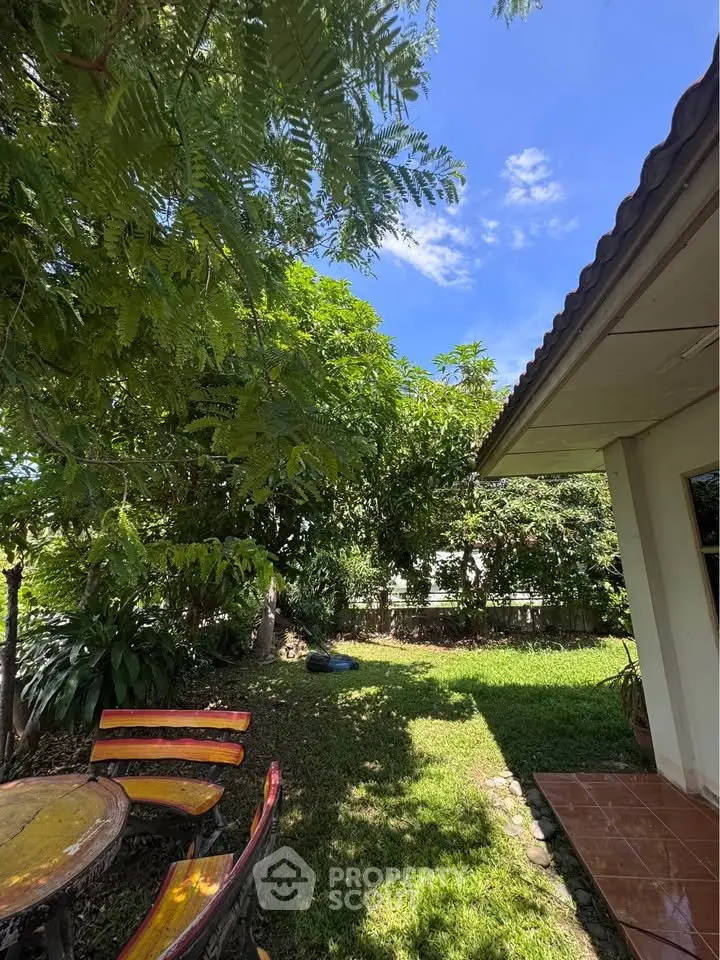Charming garden view with lush greenery and outdoor seating area