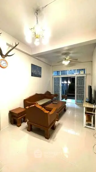 Spacious living room with elegant wooden furniture and bright lighting