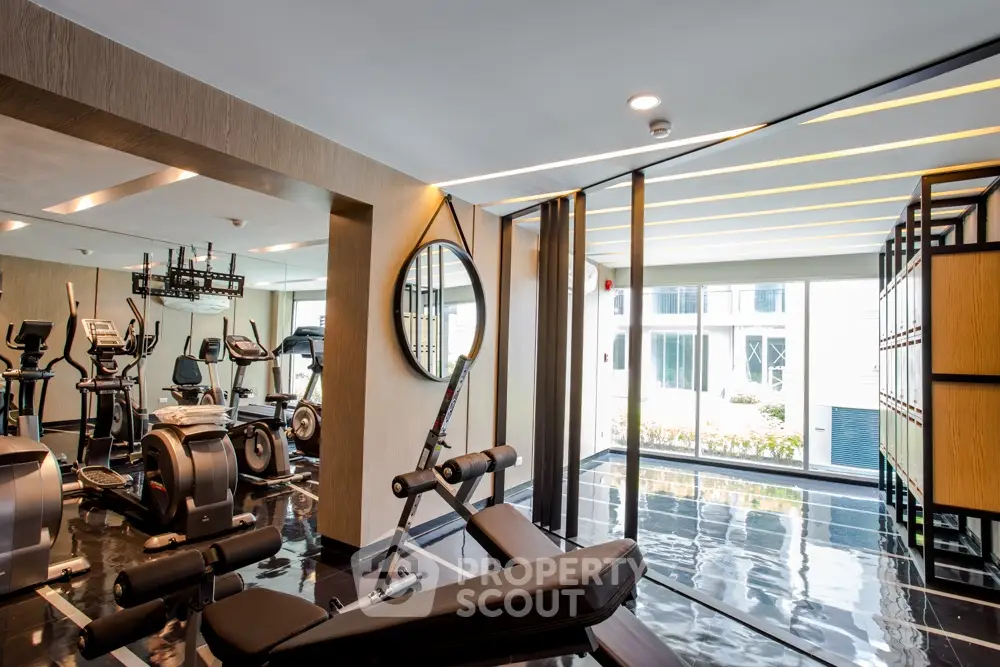 Modern gym with state-of-the-art equipment and sleek design in luxury residential building.
