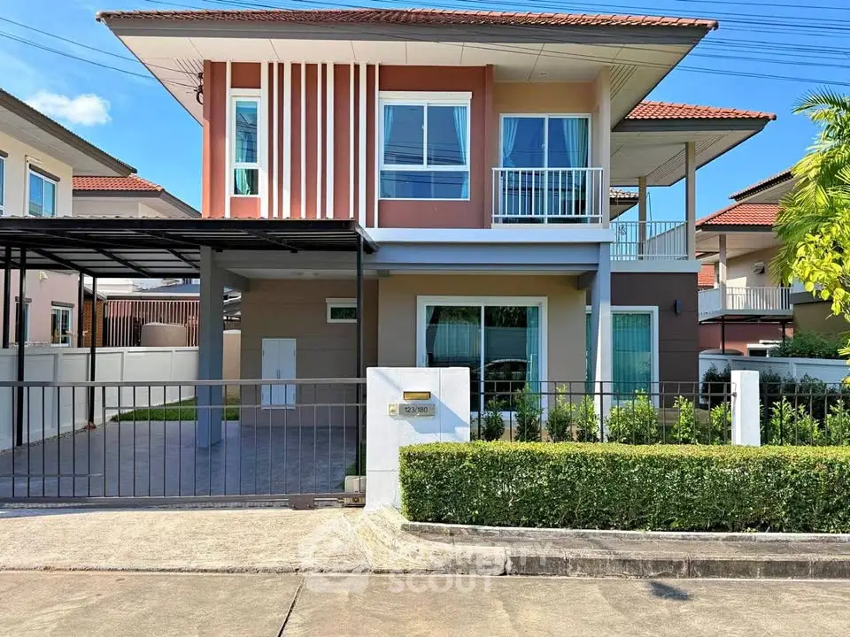 Modern two-story house with carport and landscaped front yard in a suburban neighborhood.