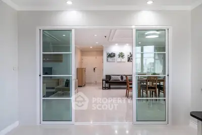 Spacious modern living room with sliding glass doors and elegant decor