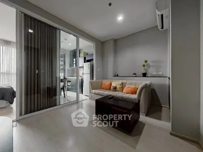 Modern living room with sleek design and open layout, featuring cozy seating and stylish decor.