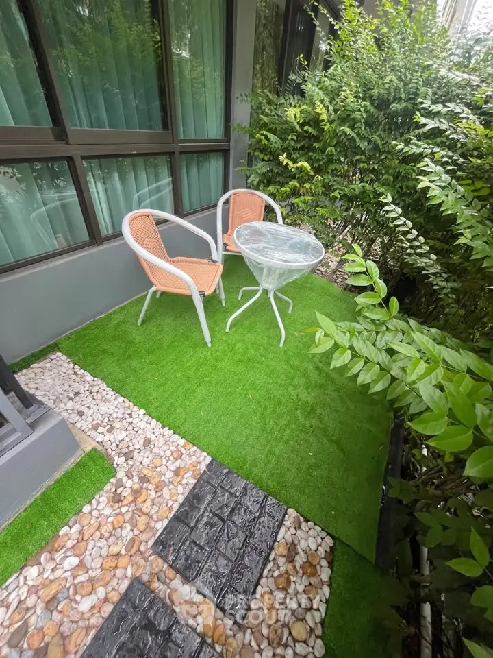 Charming garden patio with cozy seating and lush greenery, perfect for relaxation and outdoor enjoyment.