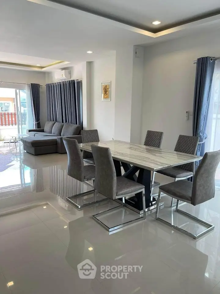 Spacious modern living room with elegant dining area and large windows