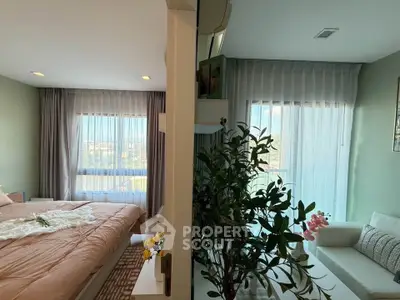 Spacious bedroom with large windows and cozy living area, perfect for relaxation.