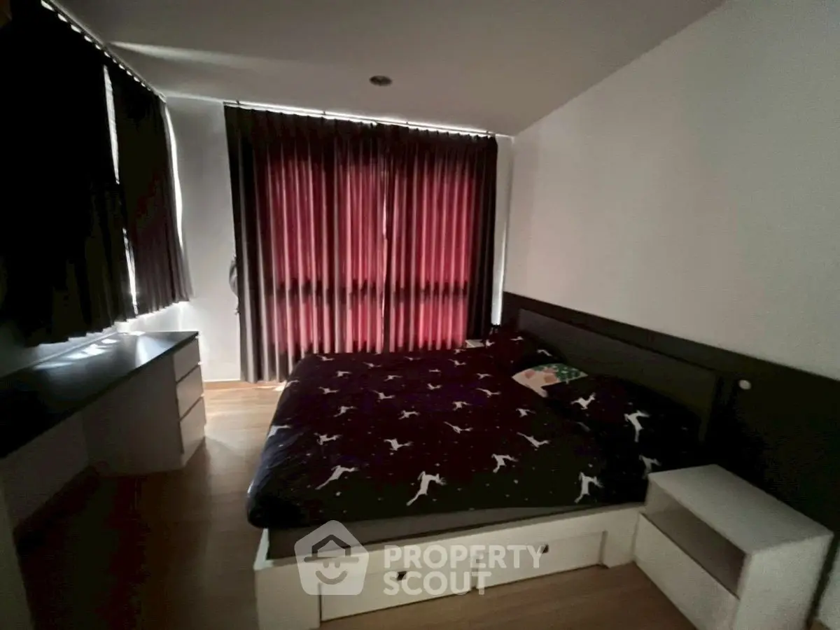 Cozy bedroom with dark curtains and modern furniture