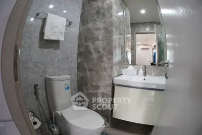 Modern bathroom with sleek fixtures and marble walls