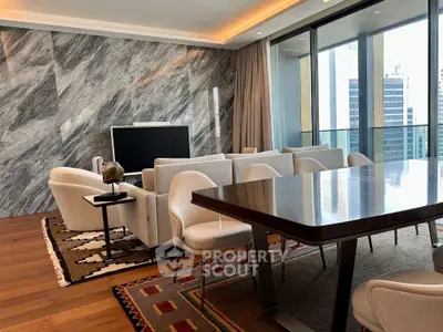 Luxurious living room with modern decor and stunning city view from large windows.