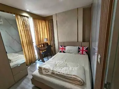 Cozy bedroom with modern decor and natural light from large windows, featuring a comfortable bed and stylish furnishings.