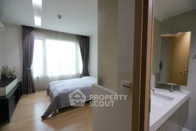 Modern bedroom with ensuite bathroom featuring sleek design and natural light.