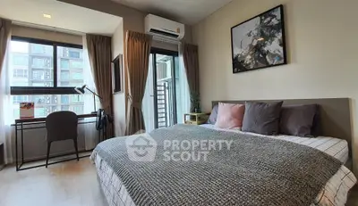 Modern bedroom with large windows and stylish decor in a high-rise apartment.