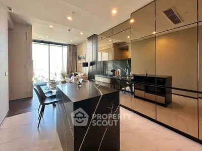 Luxurious modern kitchen with sleek black island and mirrored cabinets