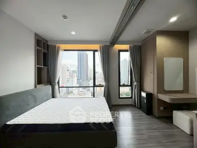 Modern bedroom with city view and stylish decor in high-rise apartment.
