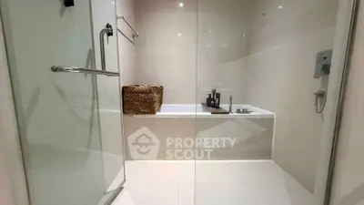 Modern bathroom with glass shower and bathtub in sleek design