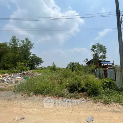 Spacious vacant land with lush greenery and clear skies, ideal for development opportunities.