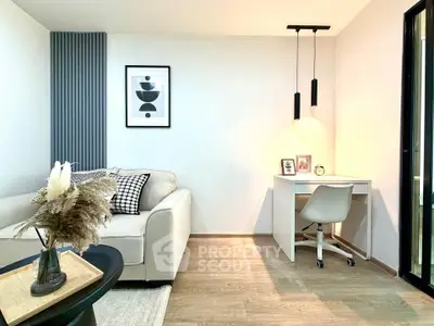 Modern living room with cozy sofa and stylish desk area, perfect for work and relaxation.